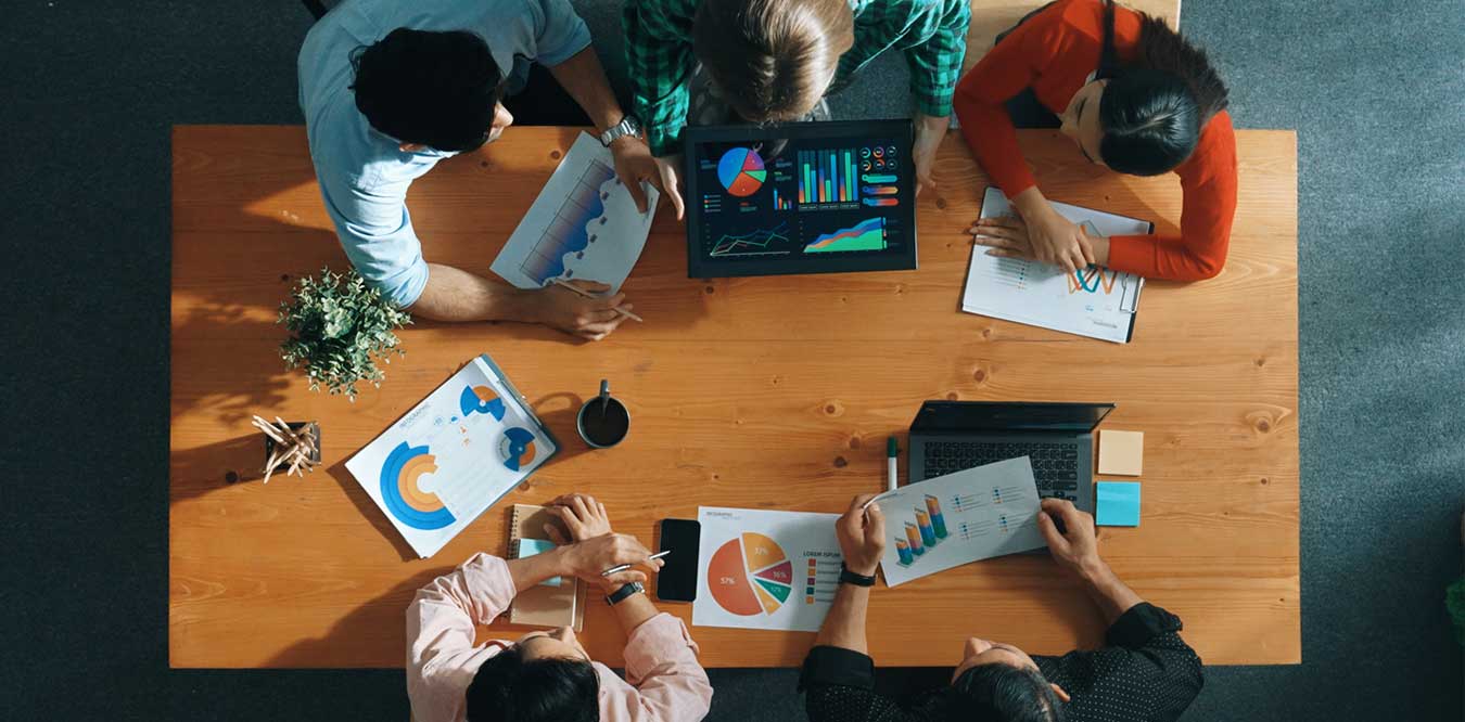 A group of diverse executives at a conference table