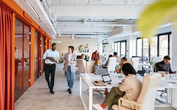 two employees walking in modern office